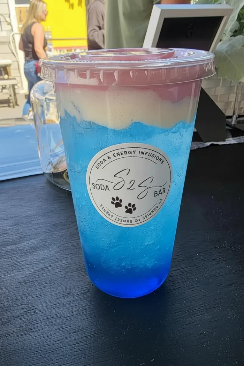 Layered blue soda with cream topping in an S2S Soda Bar cup
