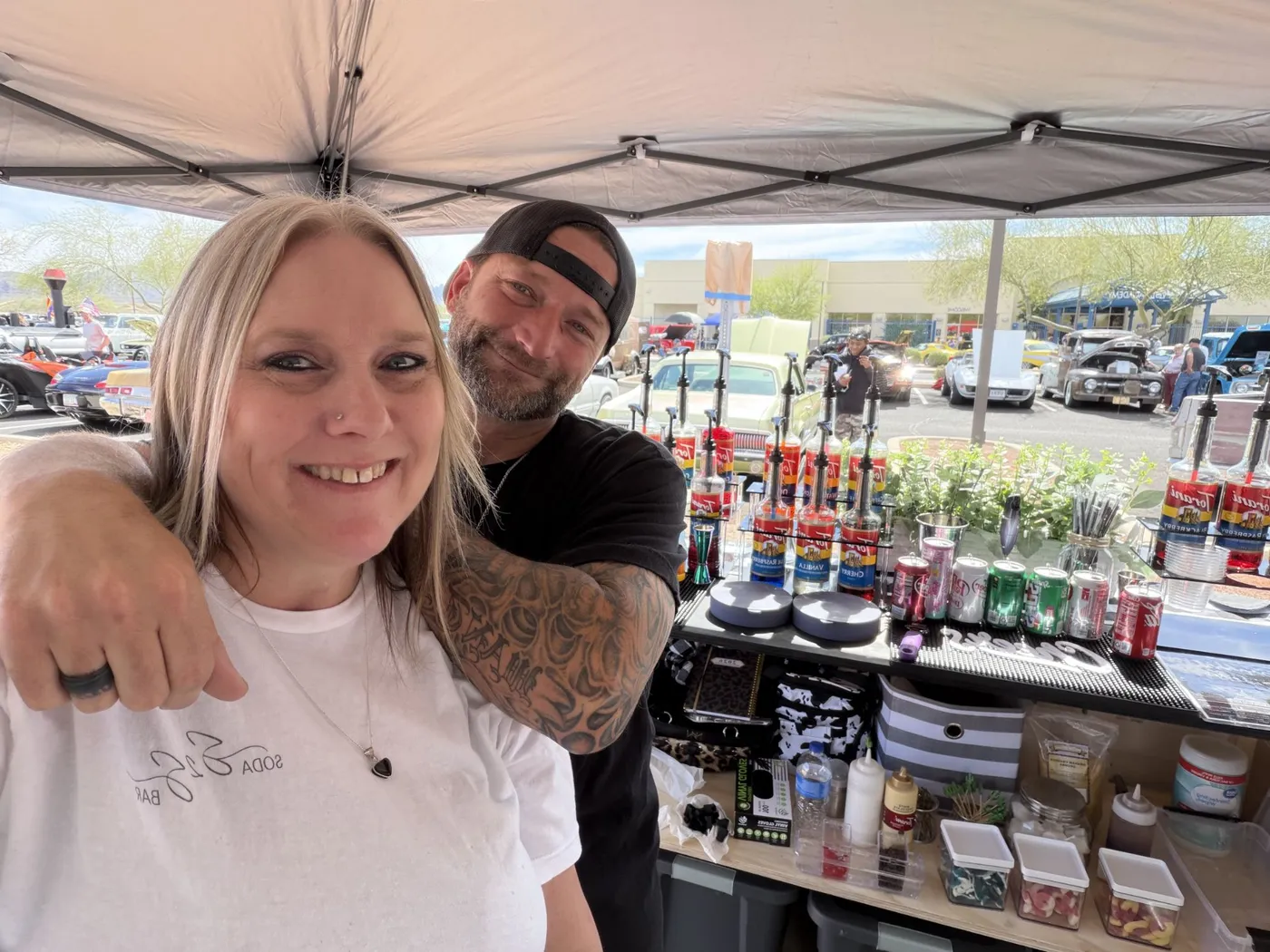 Bobbie and Jarrod behind the soda bar at a car show