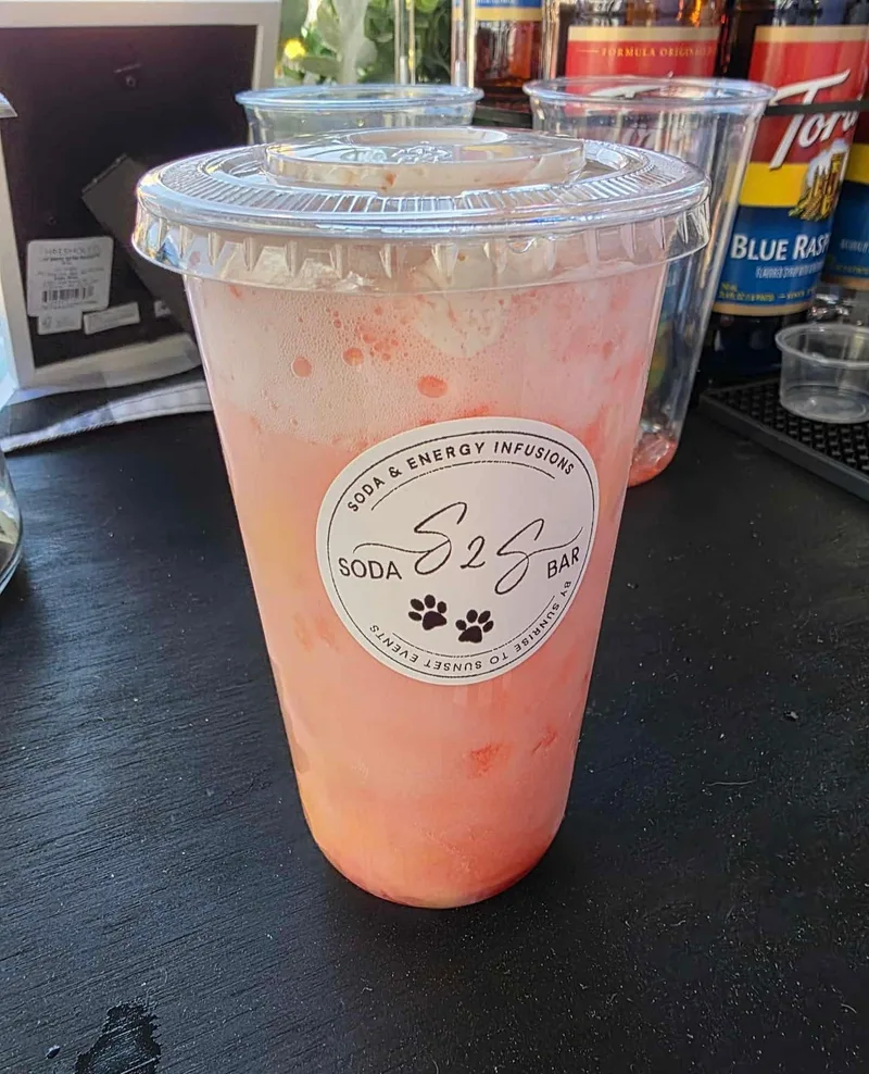 Pink strawberry soda in an S2S Soda Bar cup